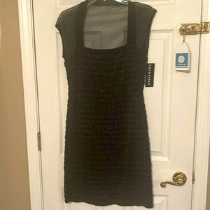 Dress, black stretchy with gold threads throughout the bodice.